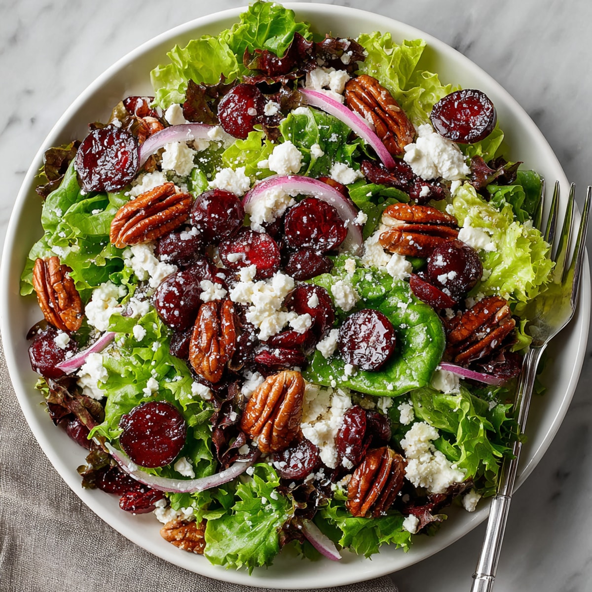 Fresh cherries and cranberries pop in this delicious Cherry-Coded Cranberry-Pecan Salad, a vibrant, healthy meal.