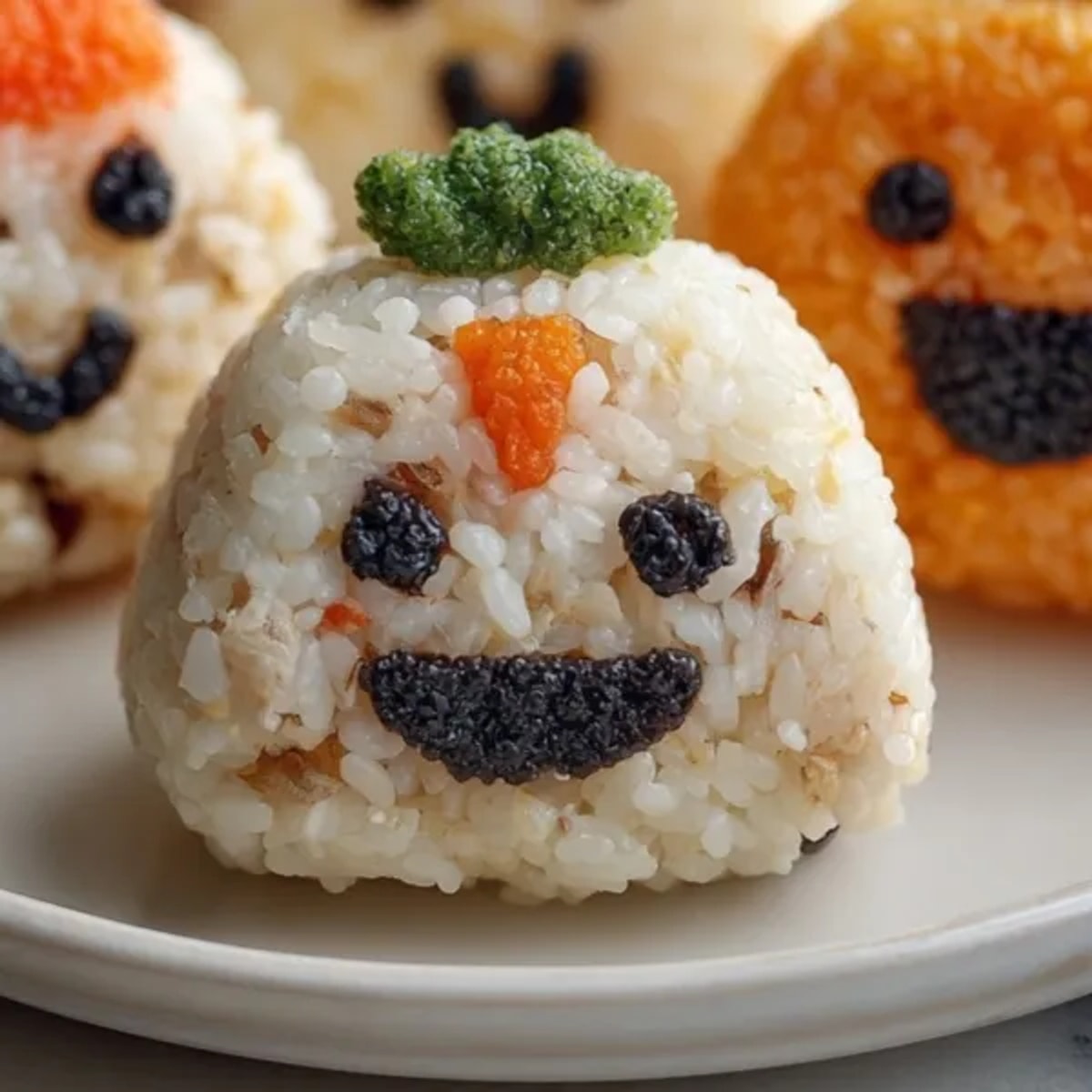 Close-up captures cute Halloween Stuffed Rice Balls, seaweed faces on glistening, warm rice.