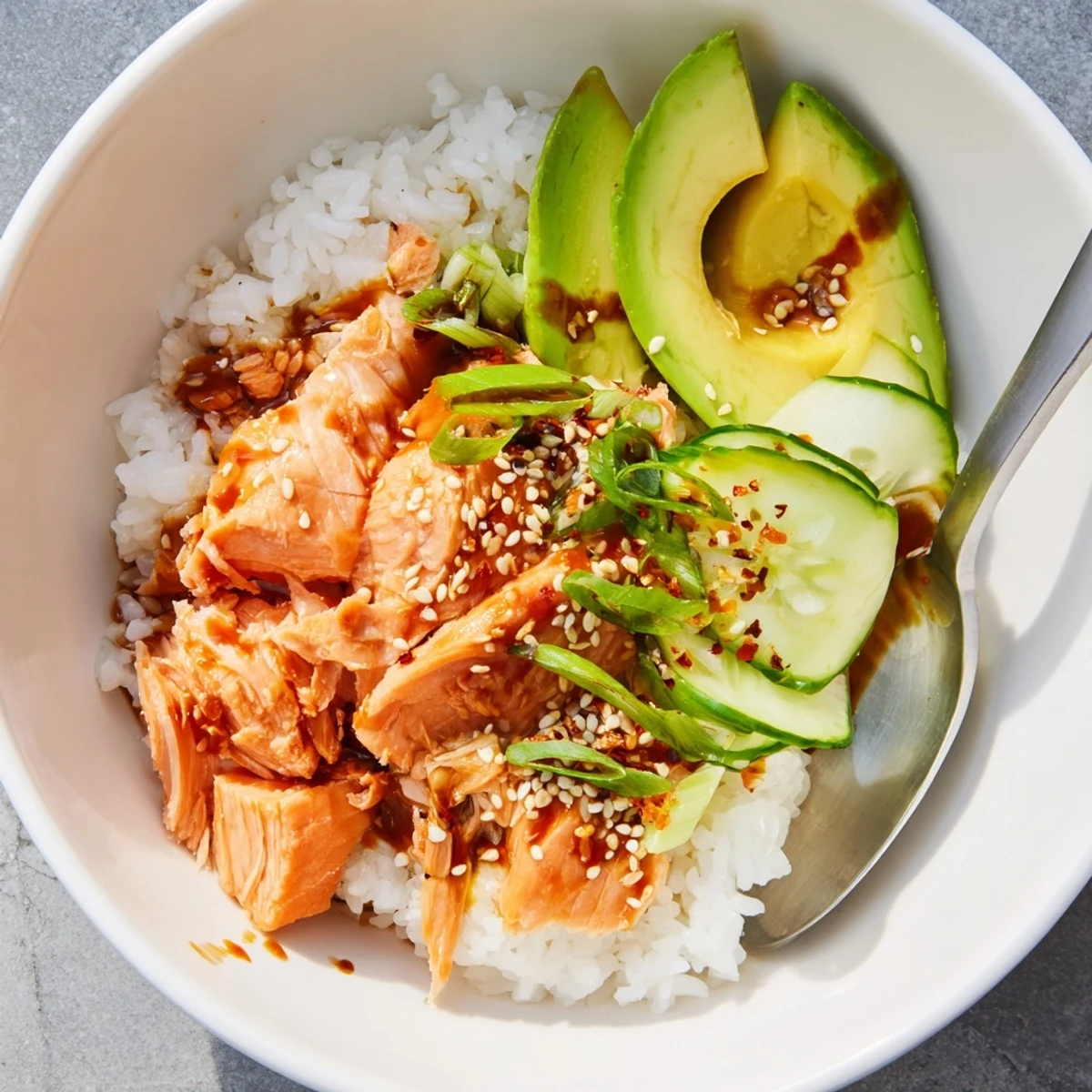 Microwave-steamed salmon paired with fresh toppings in a vibrant rice bowl.  