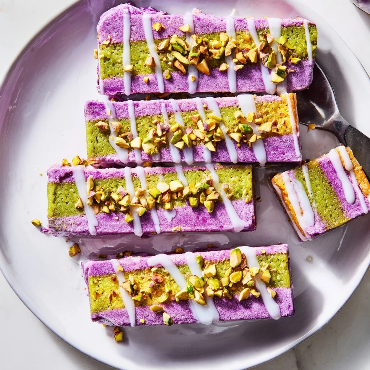 Deliciously layered ube and pistachio ice cream bars, complemented by chopped nuts.