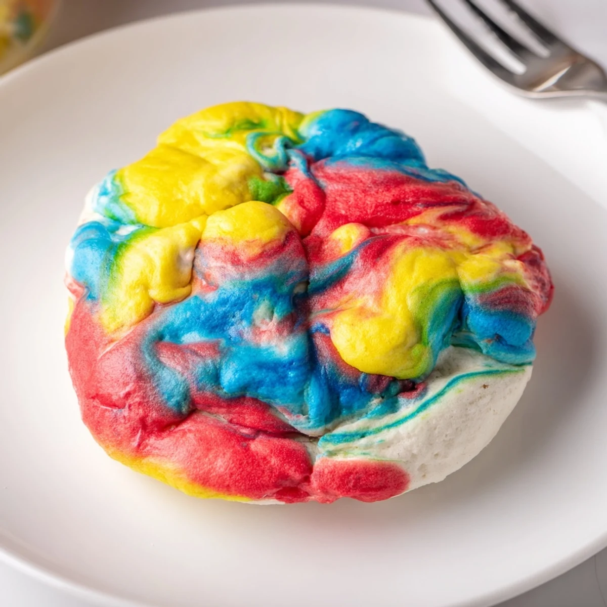 Fluffy cloud bread rainbow version topped with fresh berries for a delightful treat.  
