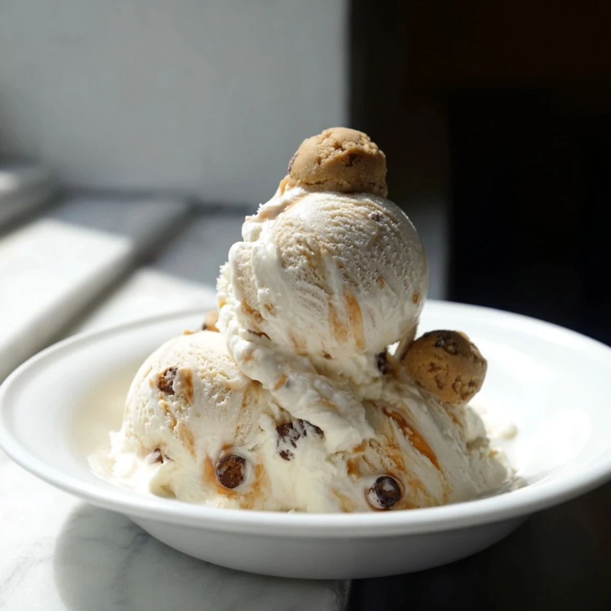 Creamy cottage cheese ice cream with chocolate chip cookie dough bites, perfect for dessert.  
