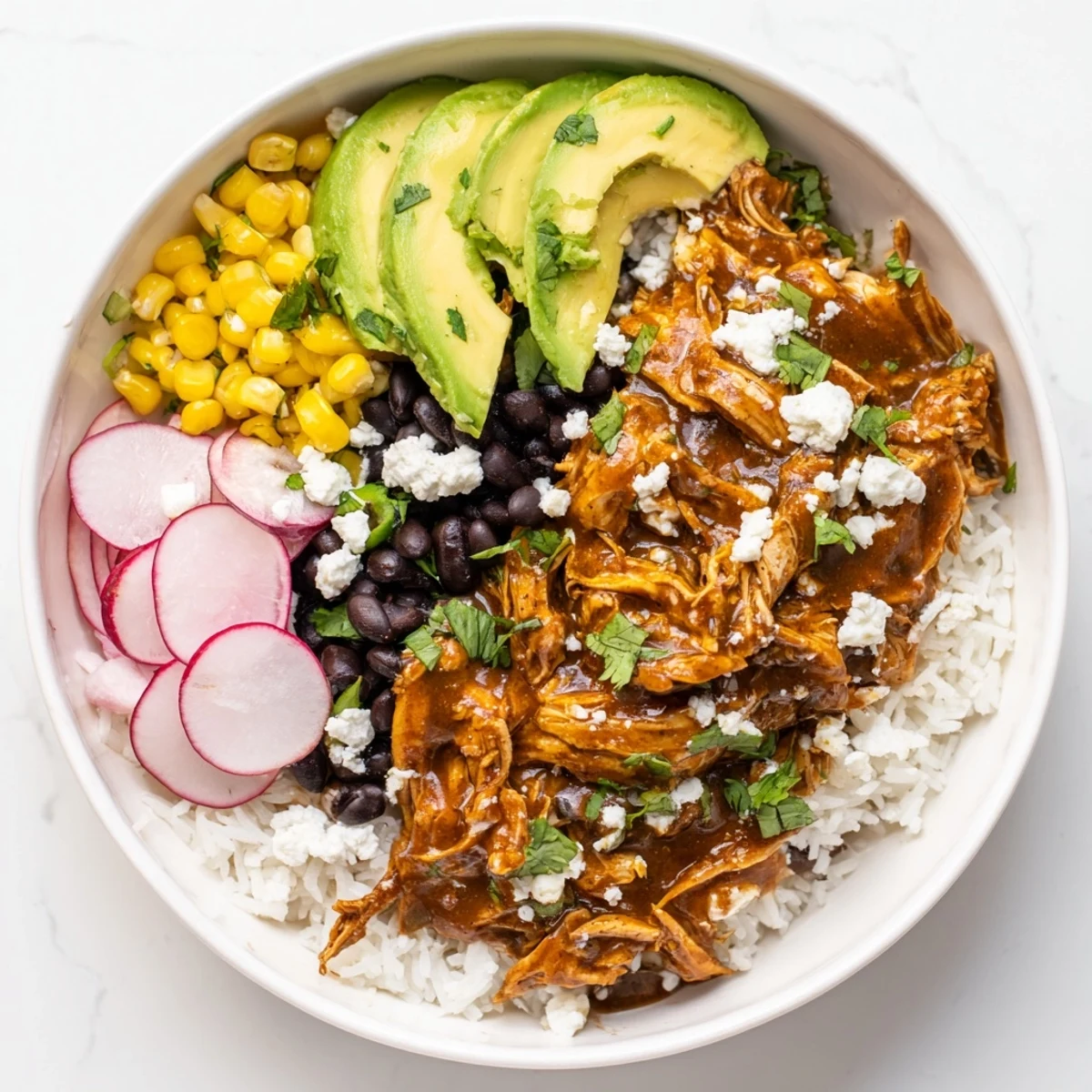 This colorful Green Enchilada Rice Bowl features chicken smothered in green sauce, ready to be devoured.