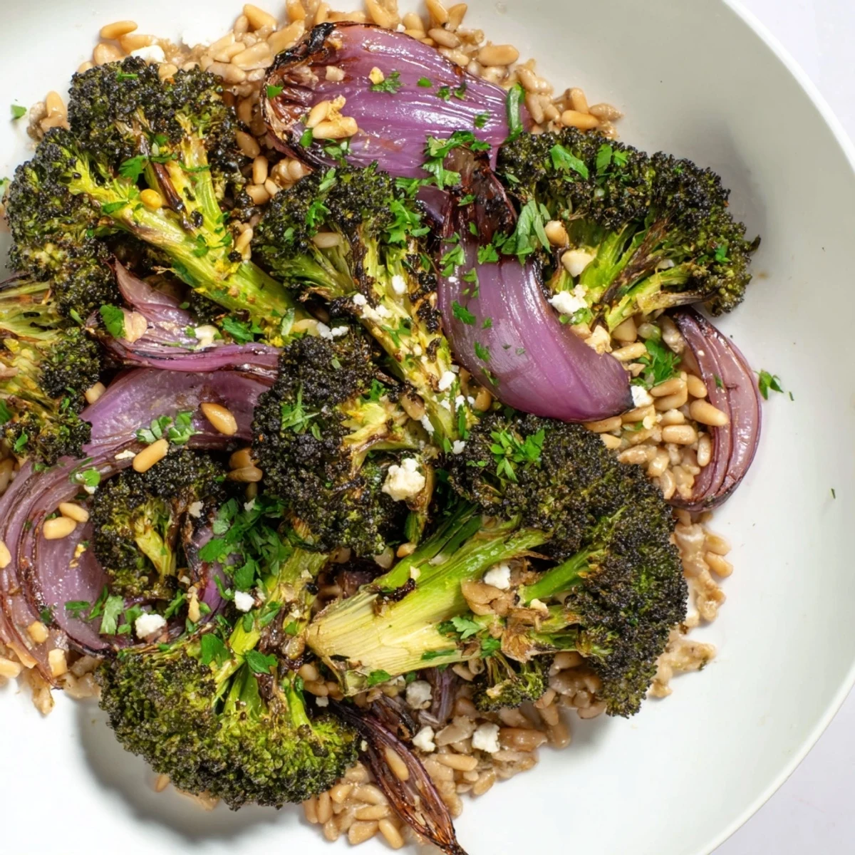 Golden roasted broccoli with garlic-lemon dressing served over fluffy farro; a delicious meal.