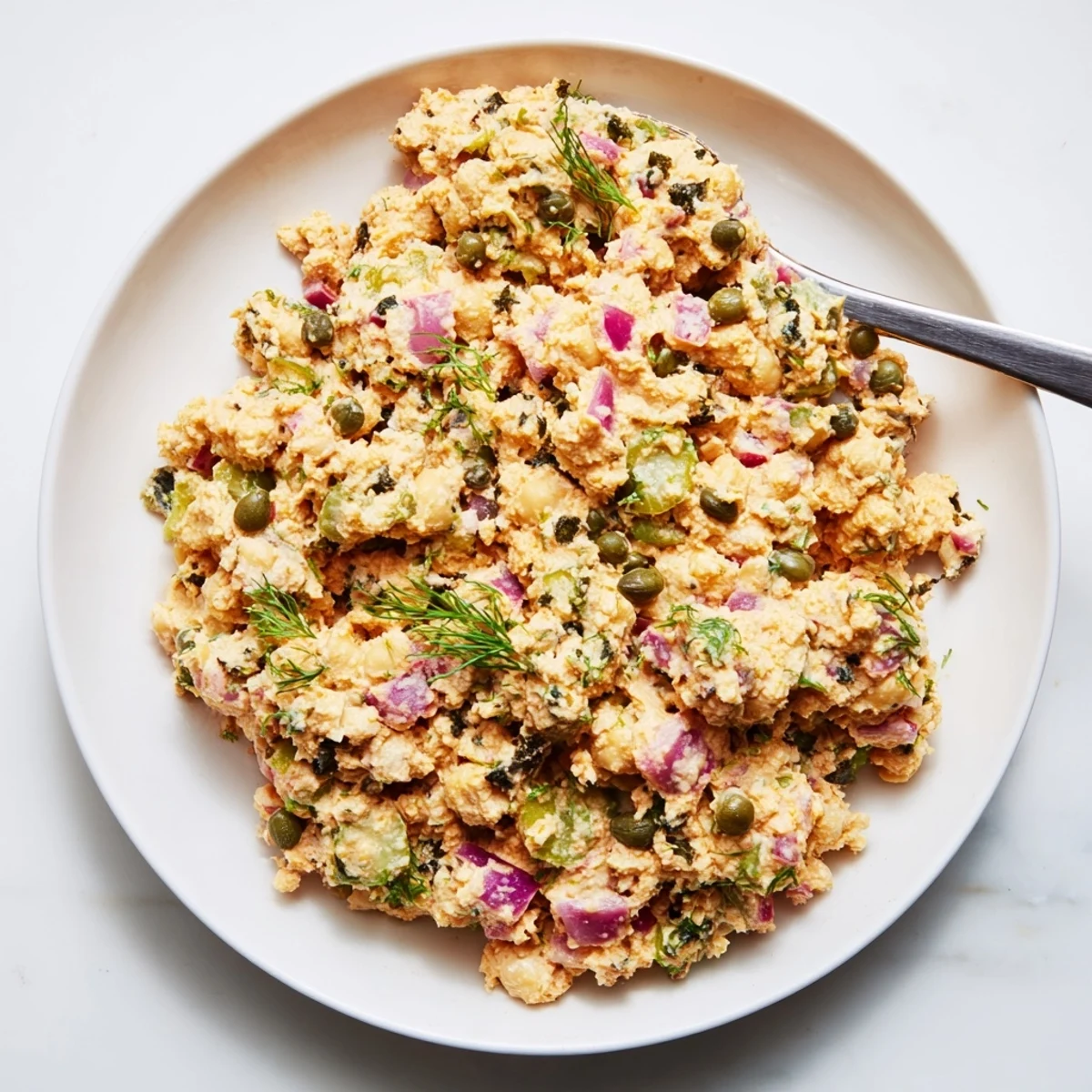 Creamy chickpea tuna salad, a vegan delight with chunky texture, perfect for sandwiches.