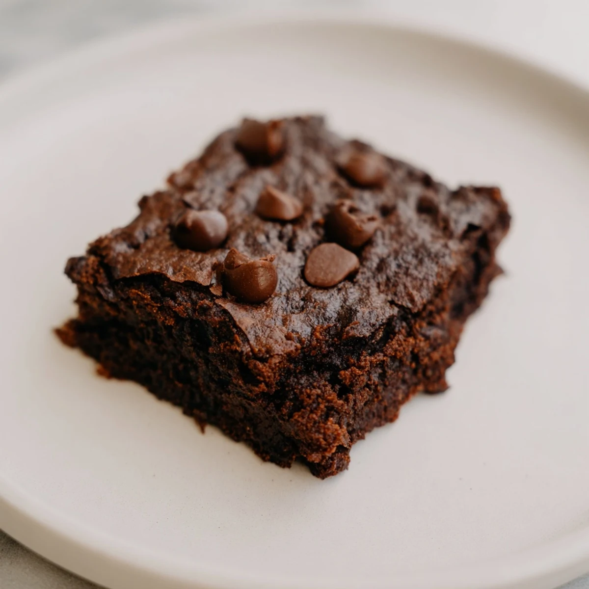 A close-up of decadent, gluten-free Black Bean Brownies, perfect with a scoop of vanilla ice cream.