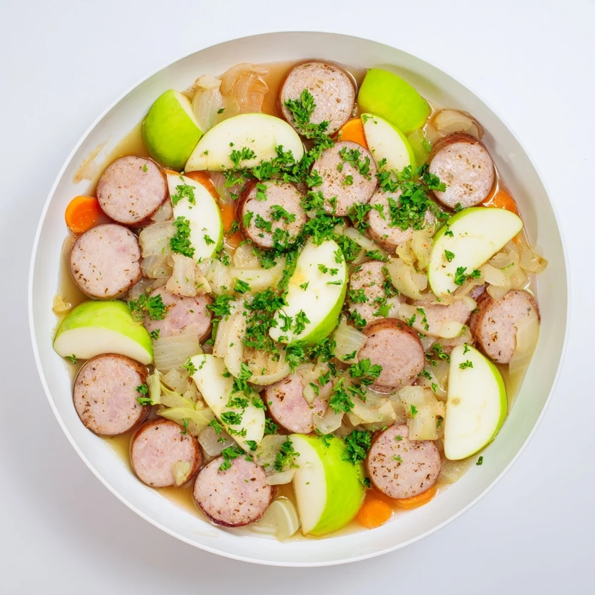 Steaming Stovetop Sausage, Celery, and Apple Hotpot with browned sausage pieces and tender vegetables.