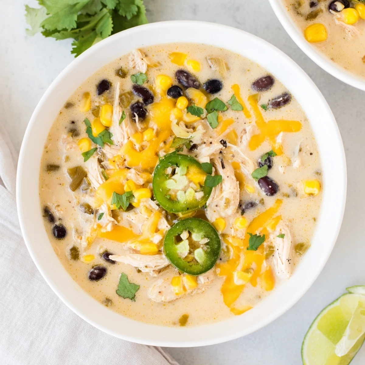 Steaming Chicken Poblano Soup, brimming with shredded chicken and vibrant peppers, ready to be served.
