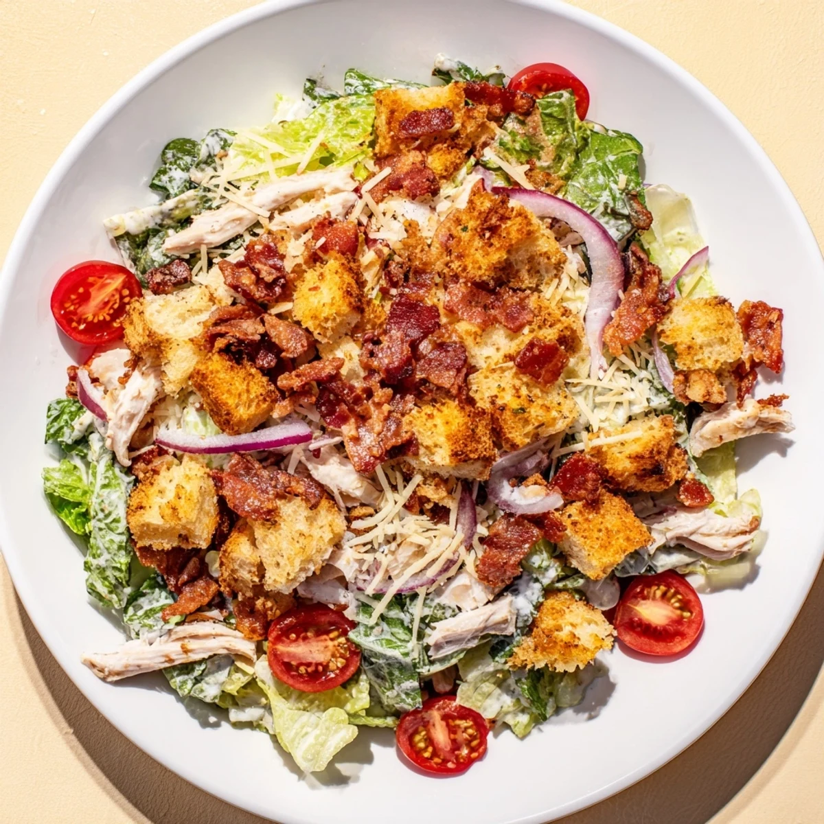 Fresh Costco Chicken Bake Salad Bowl with tender chicken, crispy bacon, and creamy Caesar dressing.