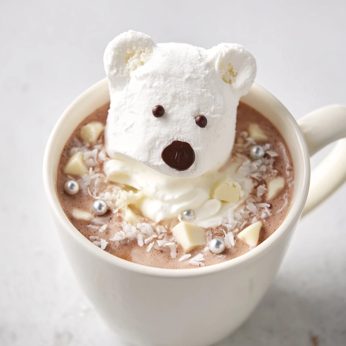 Steaming mugs of Polar Bear Hot Chocolate, a festive winter dessert, topped with polar bears and coconut.