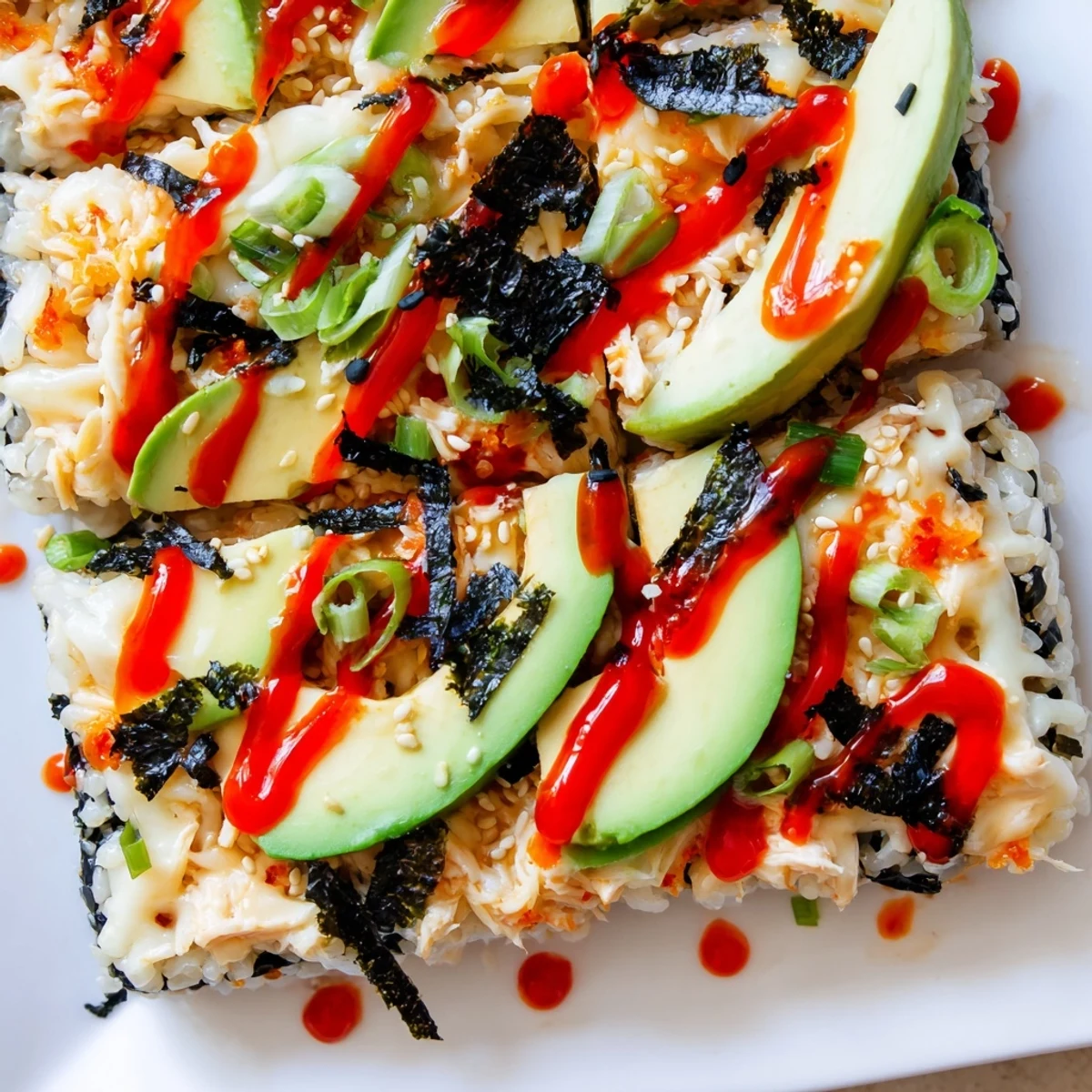 Golden Chicken Sushi Bake, topped with melted cheese and fresh avocado slices, ready to enjoy.