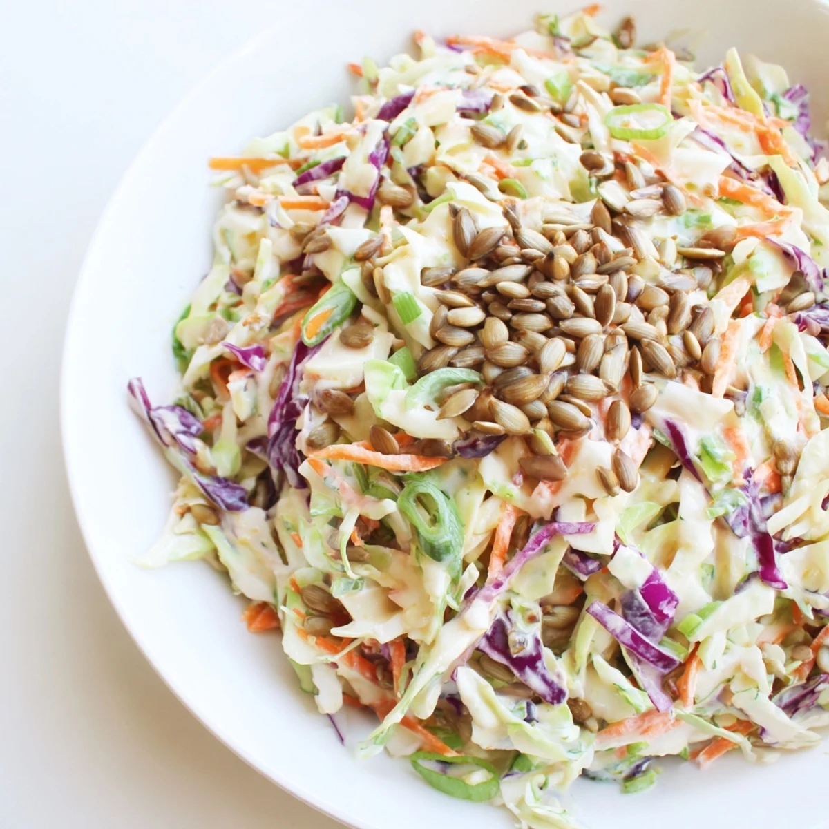 Crisp Crunchy Coleslaw Salad, a colorful mix of shredded cabbage, carrots, and creamy dressing.