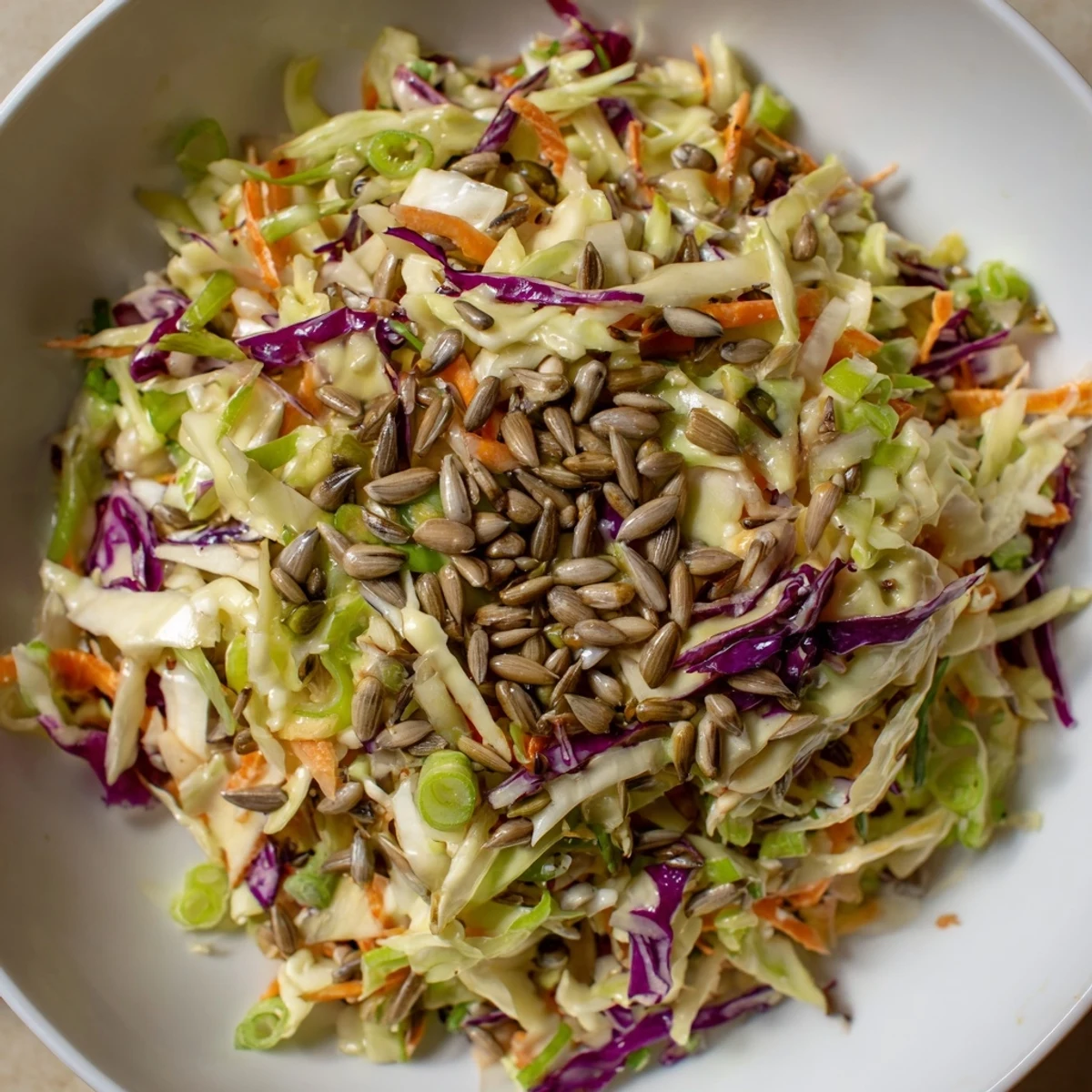 Homemade Crunchy Coleslaw Salad, with a sprinkle of sunflower seeds, perfect for a summer BBQ.