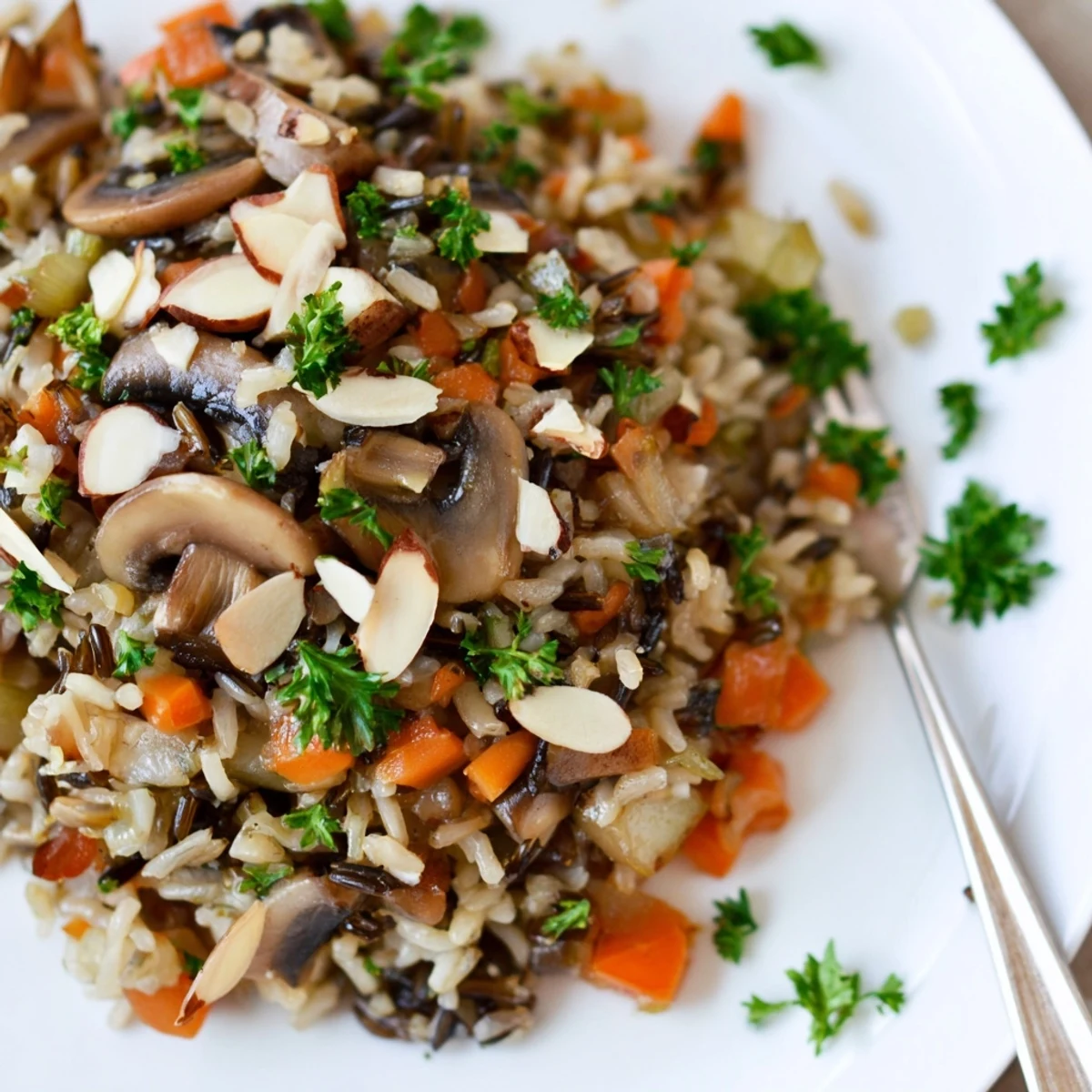 Close-up view of Wild Rice and Mushroom Pilaf featuring diced carrots and celery, highlighting the nutty grains and savory mushroom blend in a rustic serving dish.