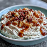 Decadent caramel apple cheesecake dip, a perfect party snack with fruit and cookies.