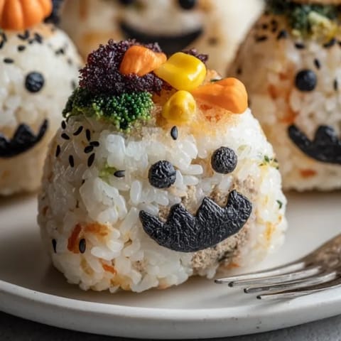 These Halloween Stuffed Rice Balls are savory, hand-formed treats with scary-cute decoration!