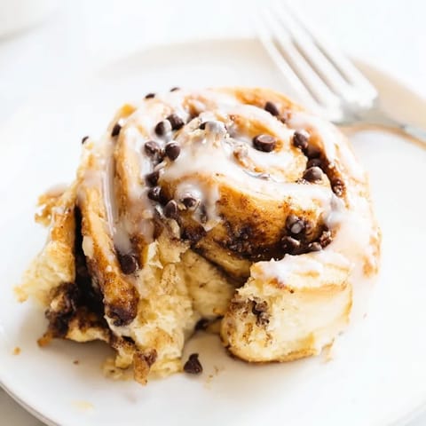 Homemade Protein Cookie Dough Sweet Rolls drizzled with vanilla glaze, ready to eat.