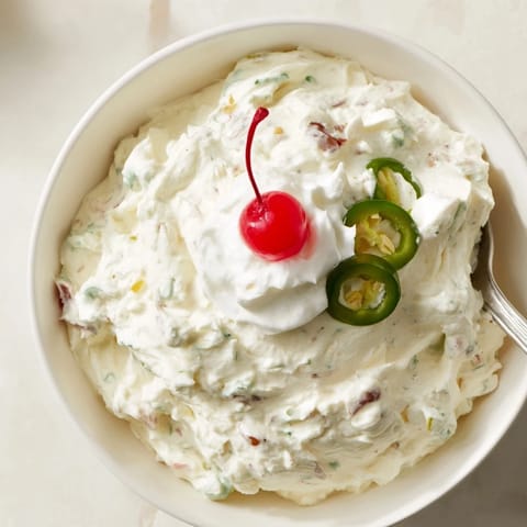 Deliciously unique Creamy Jalapeño Soda Float Dip topped with whipped cream and cherries.  