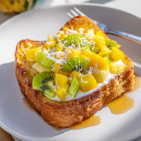 Vibrant yogurt-custard toast with sweet mango and kiwi, perfect for brunch gatherings.  