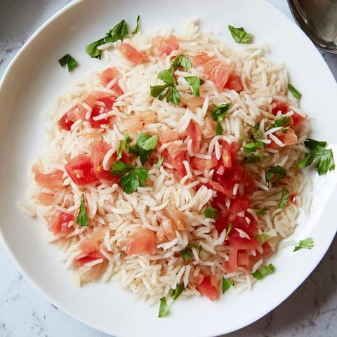 Hearty Tomato-Rice Skillet Dinner with fluffy rice, tomatoes, and aromatic seasonings, ready to serve warm.