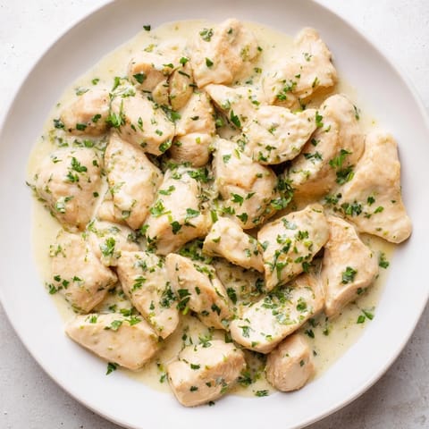 A close-up of Lighter Creamy Tarragon Chicken, showcasing the tender chicken and flavorful, herb-infused sauce.