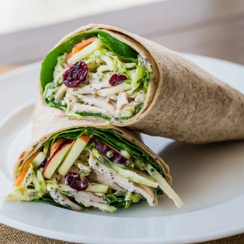Freshly made Cranberry Apple Slaw Turkey Wraps, bursting with vibrant slaw and tasty turkey filling.