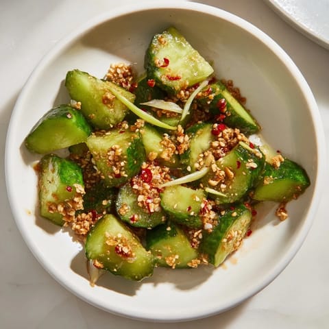 Close-up of Chinese Spicy Smashed Cucumber Salad: crunchy cucumbers with a fiery red chili dressing.