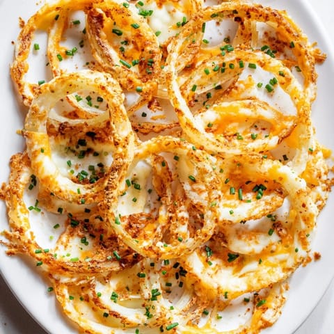 Air-fried Crispy Onion Cheese Chips, showing melted cheese bubbling atop tender, flavorful onion rings.