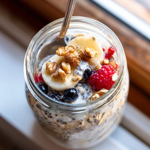 Overnight Oats with Chia Seeds topped with chopped almonds and a swirl of honey, showing a creamy, thick texture perfect for a quick, healthy morning meal.