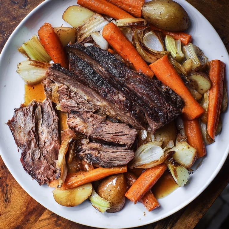 Hearty Sunday Pot Roast: succulent beef alongside perfectly roasted carrots and potatoes.